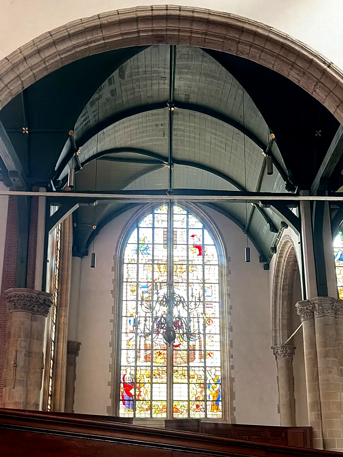 Houten tongewelf en een van de Goudse Glazen boven het koorhek